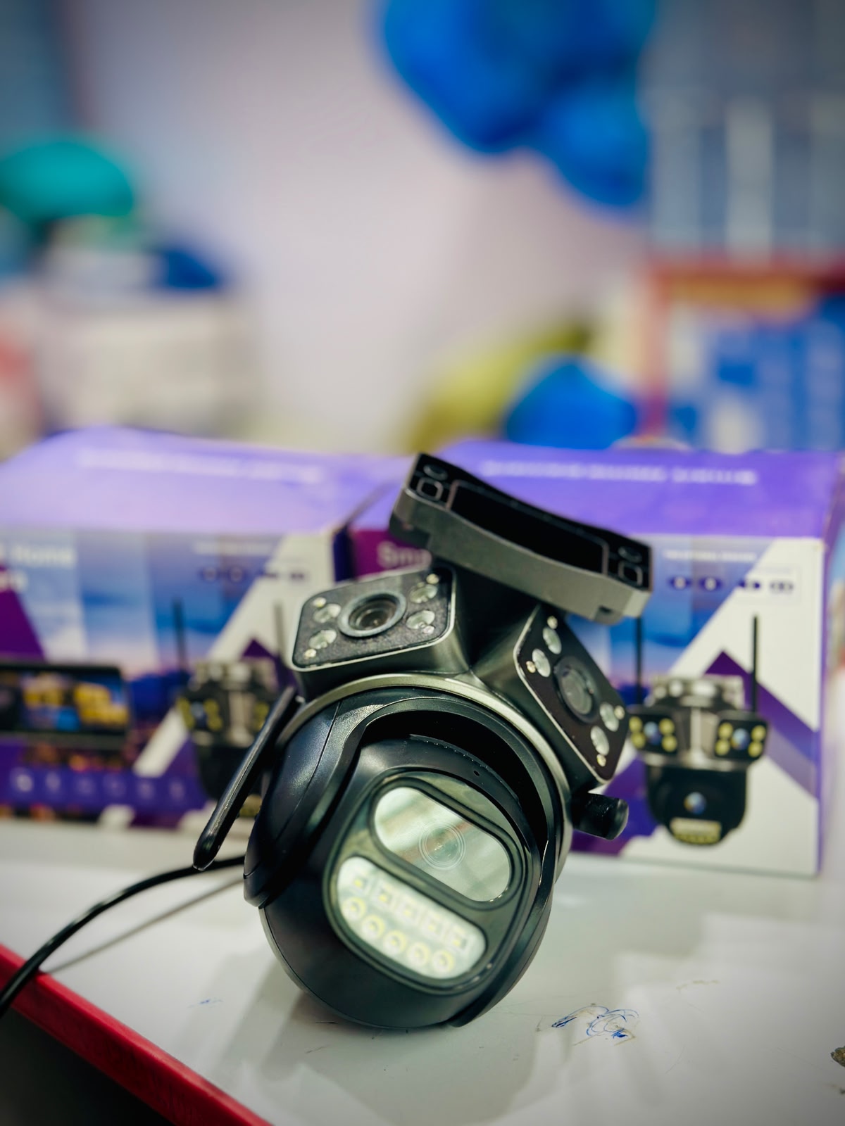 Black camera lens with a blurred colorful background